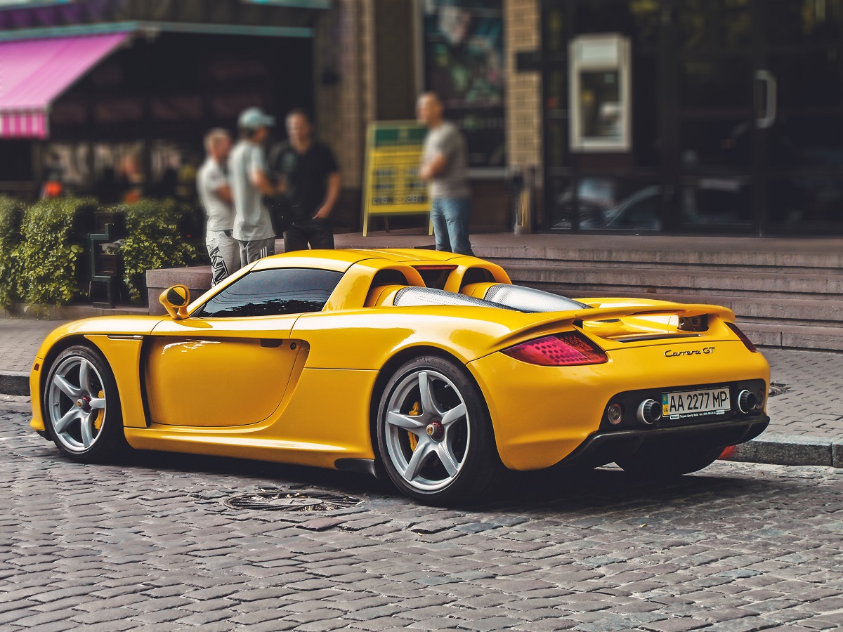 Kiev, Ukraine - June 12, 2011: Yellow supercar Porsche Carrera GT in the center of city. Exclusive car Porsche